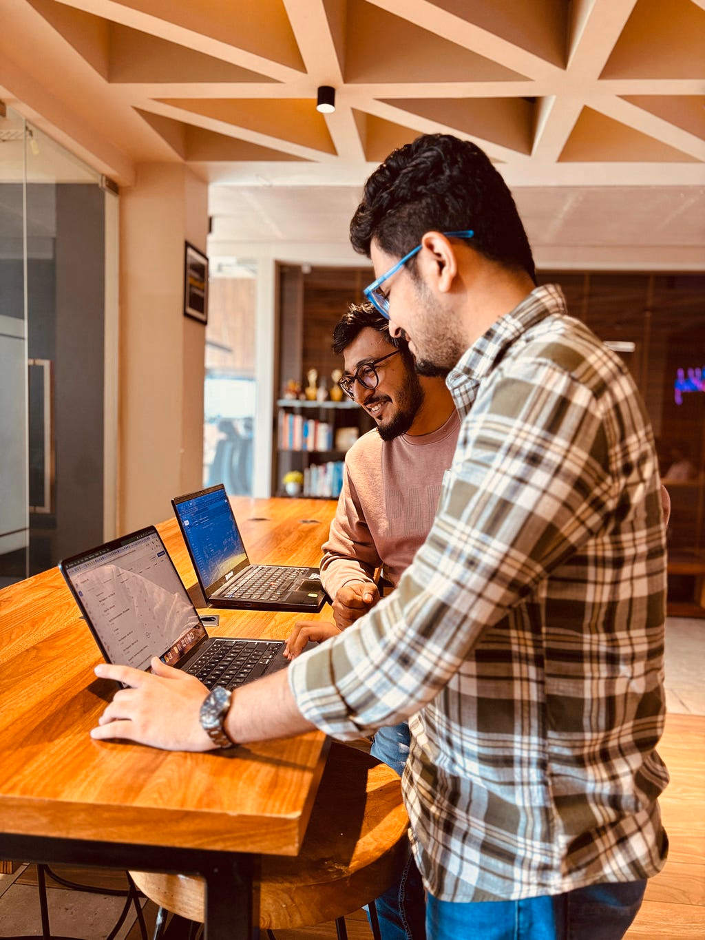 Teammates pairing on laptops during onboarding at ikigai