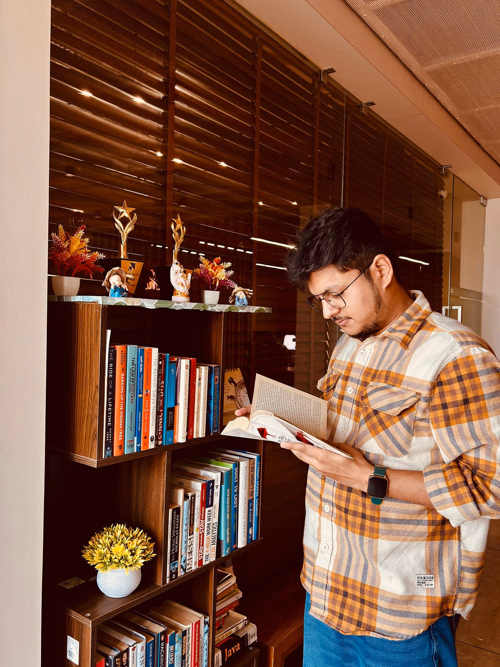 A teammate browsing the office library at ikigai