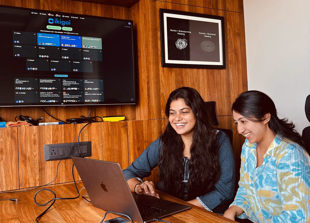 Two ikigai teammates working together at a laptop